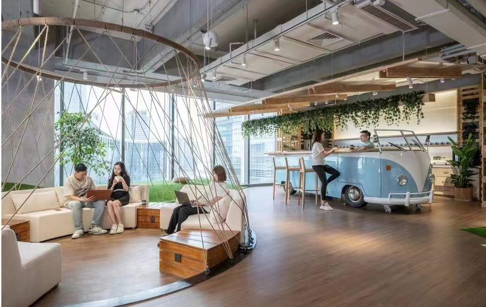 Open cafe and shared seating surrounded by plants
