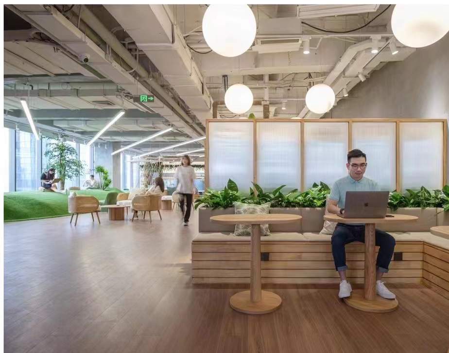 Community space with timber seating and globe lighting
