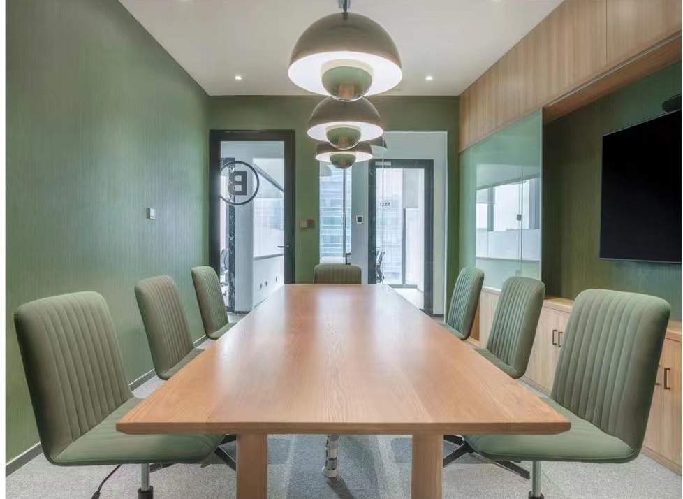Green meeting room with a timber table